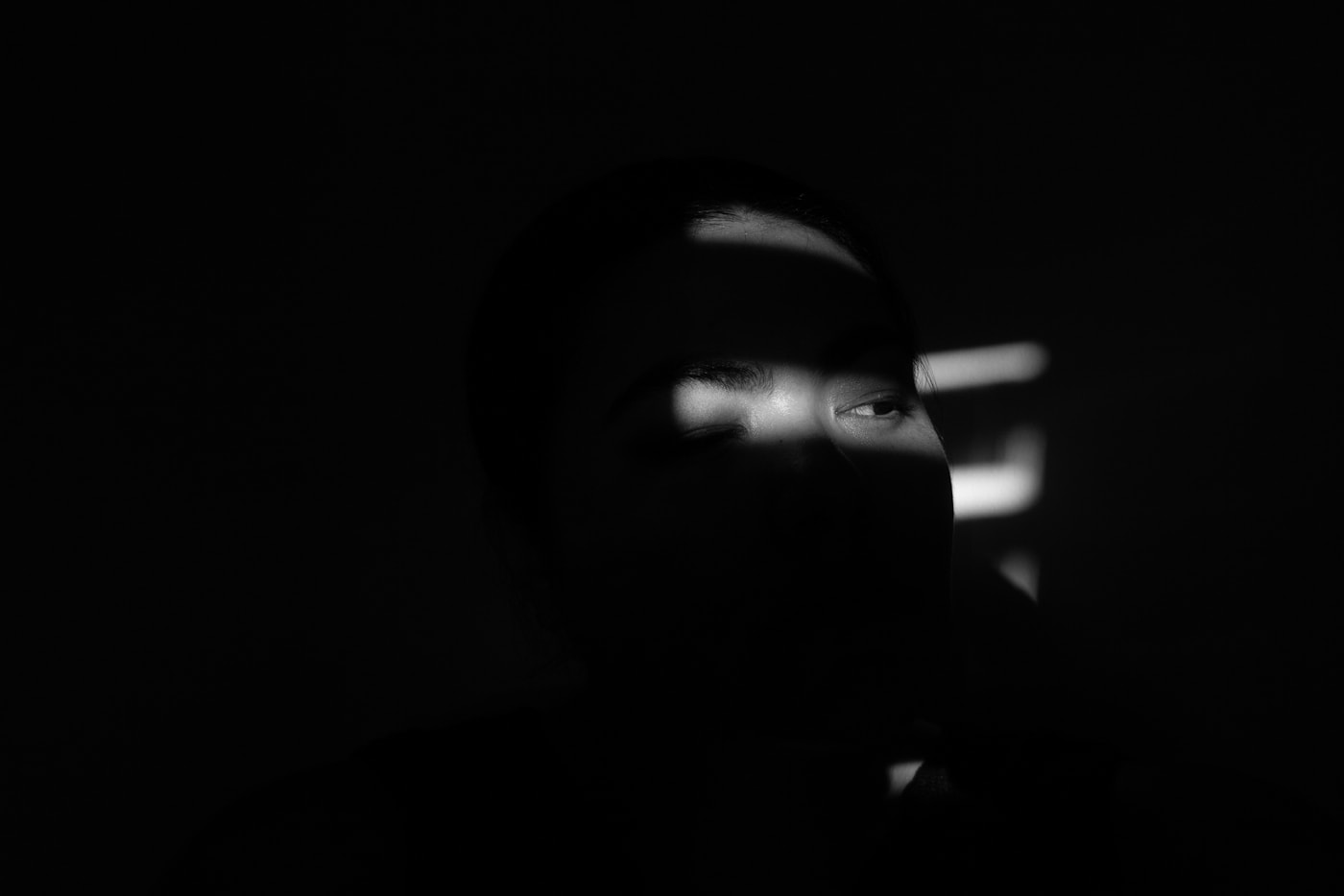 A person lit by a phone in a dark room